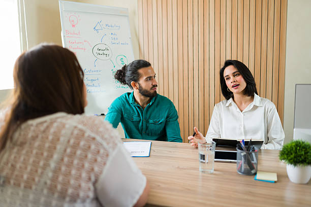 istock Latin recruiters talking about a job offer to a candidate during an interview 2210298382