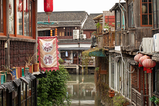 Tranquil canal scene in traditional chinese town with lanterns and rustic architecture. Zhujiajiao Ancient Town. Concept of China
