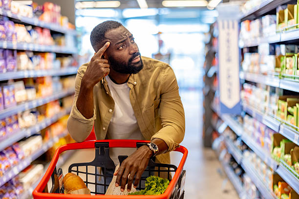 istock Man Shopping in Supermarket Displaying Thoughtful and Contemplative Expression 2210300184
