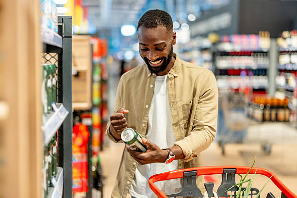 istock Smiling Man Shopping in Supermarket While Checking Product 2210300198