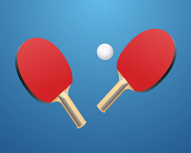istock Two Red Table Tennis Paddles with White Ball on Blue Background 2210302563