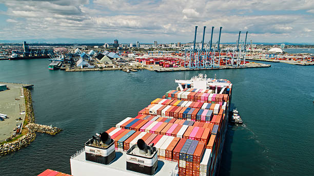 istock Tugboats Guiding Container Ship into Long Beach Harbor 2210314572