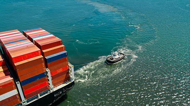 Aerial shot of a container ship arriving in the Port of Long Beach in California on a sunny day. \n\nAuthorization was obtained from the FAA and Port of Long Beach for this operation.