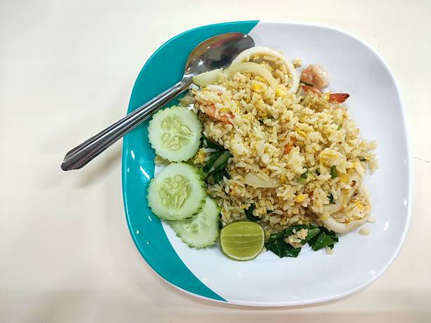 Seafood fried rice on a plate with a spoon