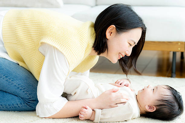 istock mom playing with baby 2210320120