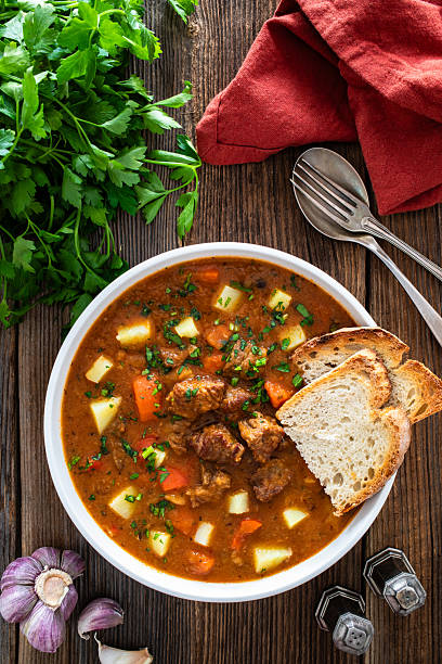 istock Beef stew with vegetables and potatoes on wooden table 2210323840