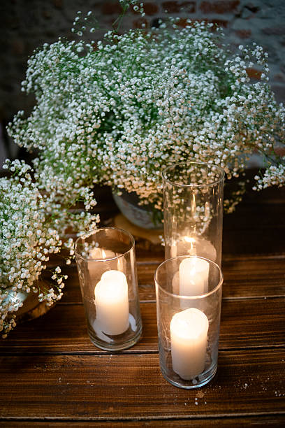 istock Candles and gypsophila on a rustic table 2210327340