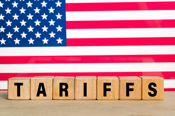 istock tariffs word text on wooden blocks on america flag in the background 2210328233