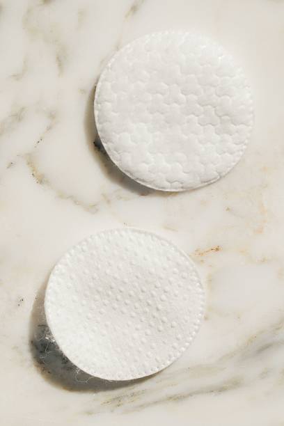 istock two cotton rounds on white marble bathroom counter 2210332235