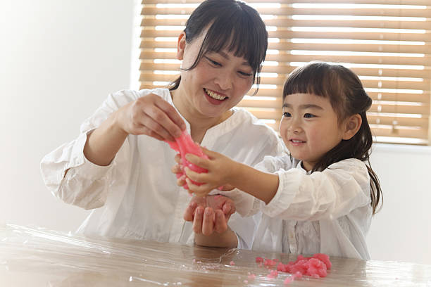 istock Parents and children making slime 2210333702