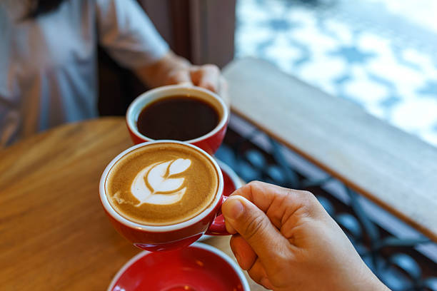 istock Coffee toast with black coffee and latte in red cups at a cafe 2210336071