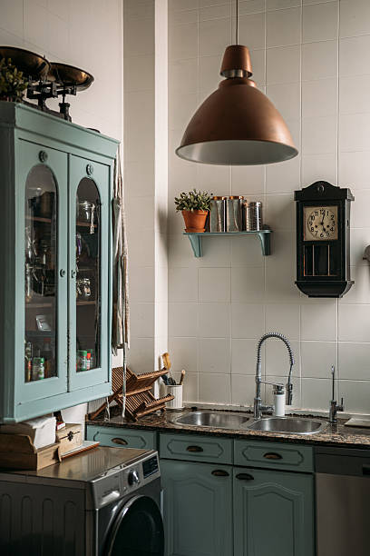 istock Vintage kitchen with pastel cabinets, a copper lamp, and antique decor elements 2210337737