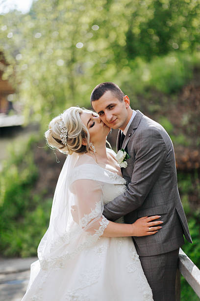 istock A bride and groom are hugging each other on a bridge 2210338872