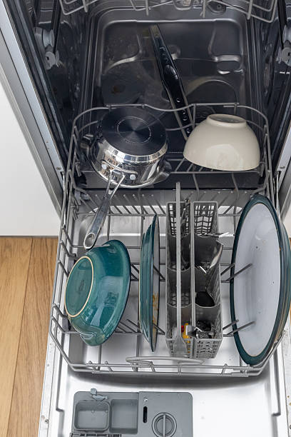 istock Items loaded into open dishwasher, Wirral, Merseyside, England, Britain 2210340487