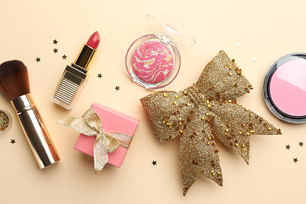 istock Flat lay composition with makeup products and Christmas decor on beige background 2210342014