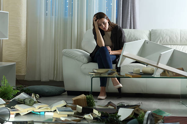 istock Sad woman after robbery at home complaining in the night 2210342348