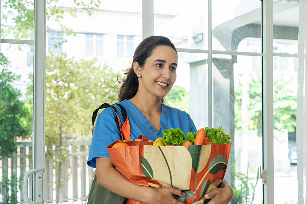 istock Healthcare Worker Carrying Fresh Groceries Outdoors After Work 2210342373