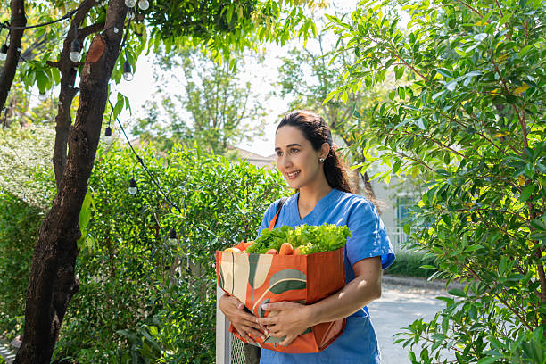 istock Healthcare Worker Carrying Fresh Groceries Outdoors After Work 2210342379