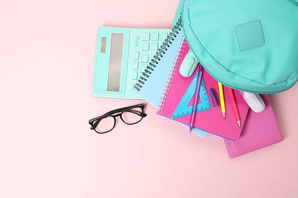 istock Backpack with different school stationery on pink background, flat lay 2210342819