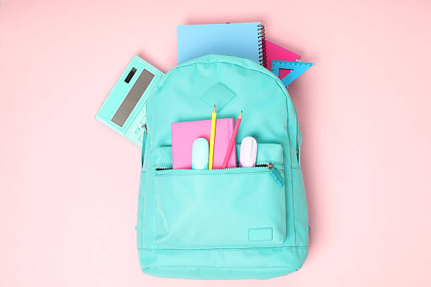 istock Backpack with different school stationery on pink background, top view 2210342852
