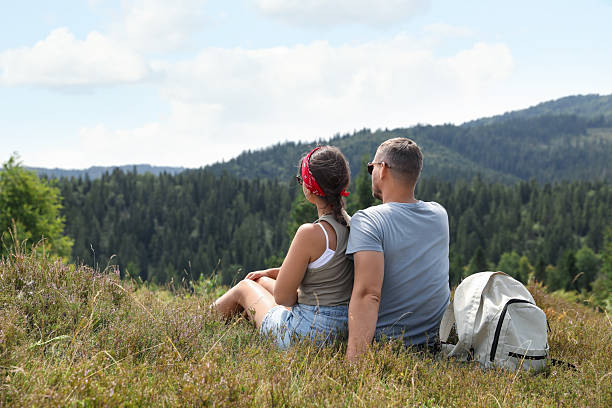 istock Couple with backpack enjoying picturesque landscape, back view. Active tourism 2210343394