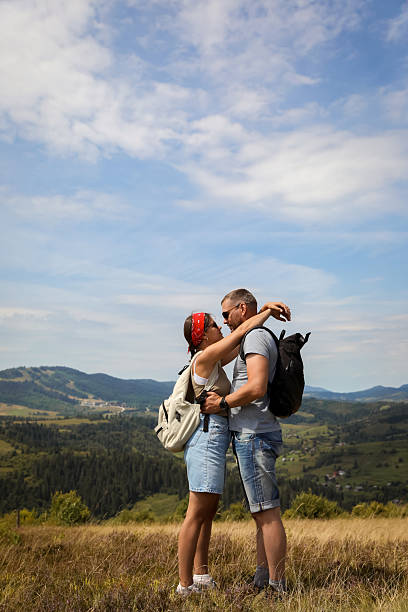 istock Couple with backpacks hugging outdoors. Active tourism 2210343501