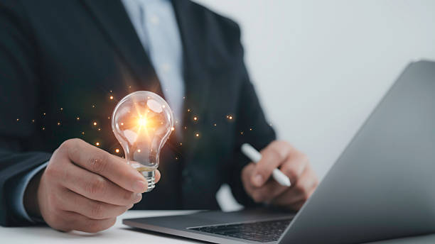 istock Businessman holding a glowing lightbulb, representing creativity, innovation, and new ideas in business. startup concepts, leadership and technology-driven growth 2210347014