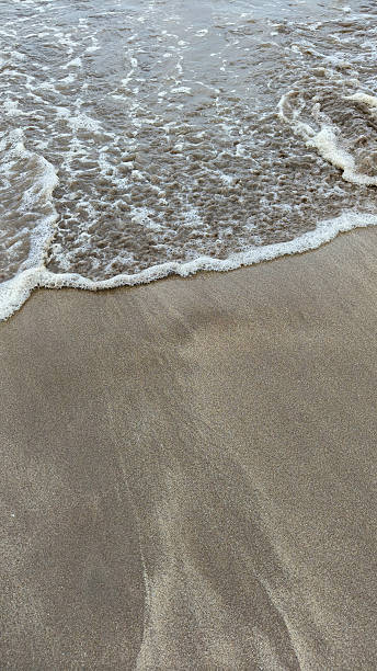 istock Soft sea wave on sand beach, natural background 2210347724