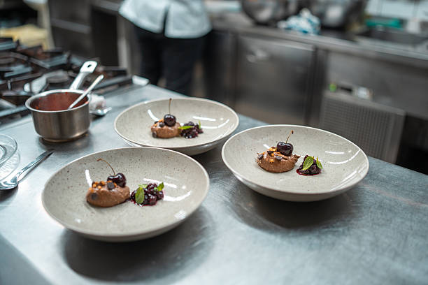istock Elegant Plated Desserts in Modern Professional Kitchen Setting with Gourmet Presentation 2210347742