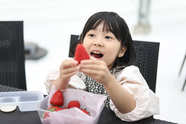 Girls enjoying strawberry picking