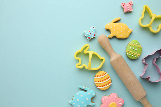 istock Easter biscuit moulds in pastel colours. Easter egg, bunny and chicken. Happy Easter day concept. Minimal concept. Space for text. Easter cookery on the background of baked goods. 2210350125