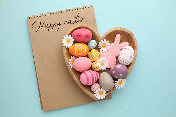 istock Easter composition. Easter eggs, flowers, paper blank on pastel background. Flat lay, top view, copy space. 2210350165