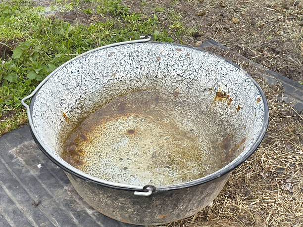 Rusty metal basin on outdoor ground surface: weathered container in natural setting.