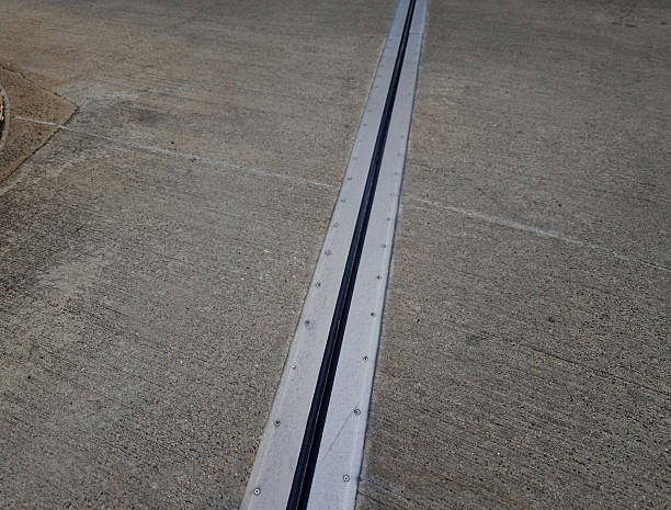 istock roof structure or bridge expansion for safe connection of two expandable concrete bodies. rubber joint in metal bar, structural modifications to buildings that prevent failures due temperature, screw 2210357135