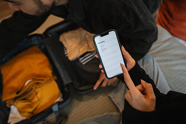 istock Couple packing clothes into travel bag 2210358765