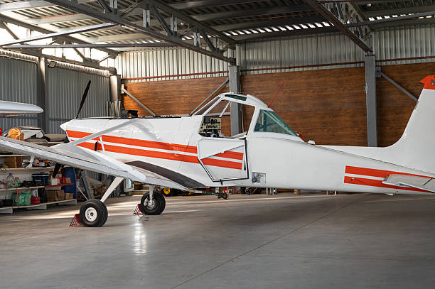 istock Small white aircraft parked in a hangar 2210358820