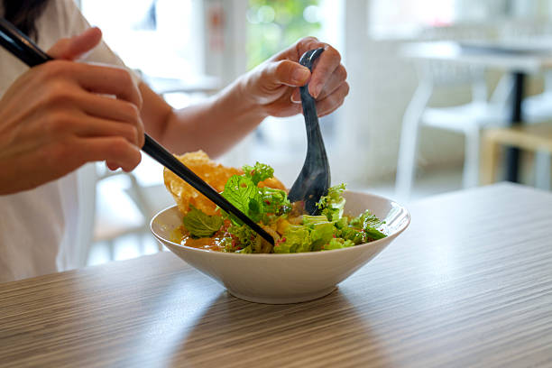 istock Malaysian asam laksa with fresh vegetables served in ceramic bowl 2210359212
