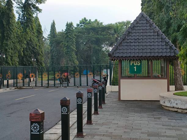 istock Row of black and brown bollards lining a road and sidewalk. 2210360029