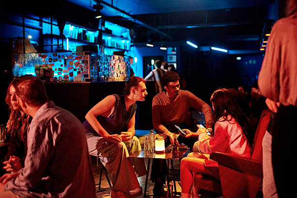 istock Young friends enjoying drinks and conversation after work 2210360051