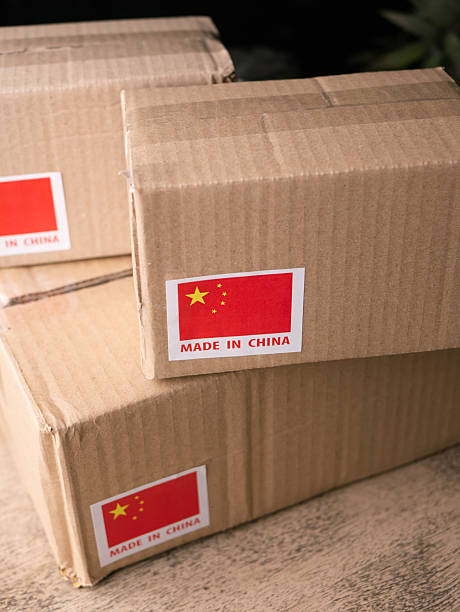 istock shipping cardboard box with MADE IN China flag label on. 2210360184