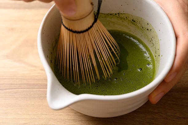 istock Matcha green tea powder mixing with water in tea bowl by using chasen 2210360410