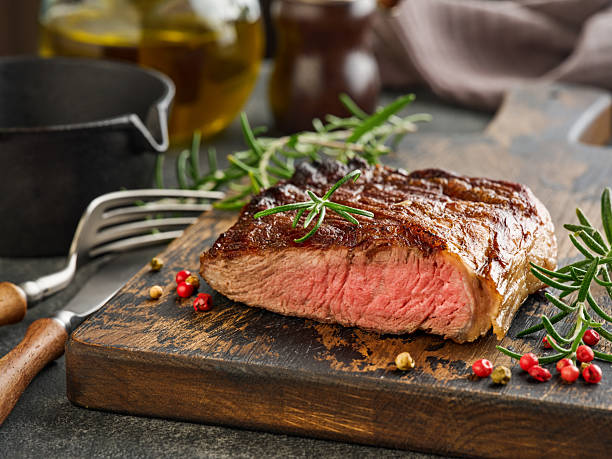 istock Beef Steak medium rare on black plate, surfed with tableware on black stone table with ample copy space. Dark background. Top view. Copy space. 2210361574