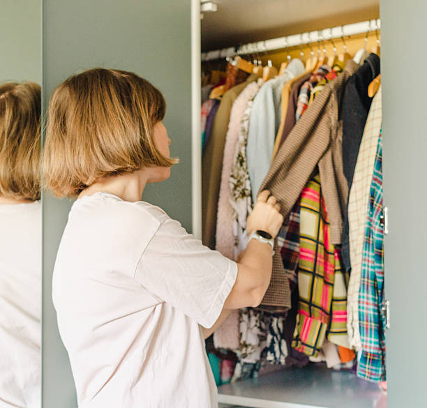 istock Woman choosing clothes from her closet 2210362007