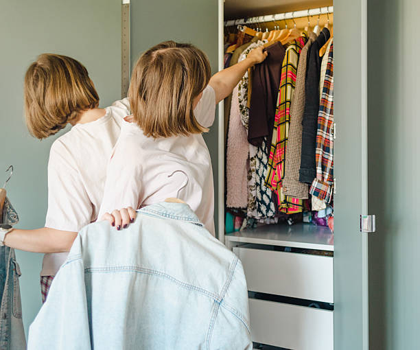 istock Woman choosing clothes from her closet 2210362070