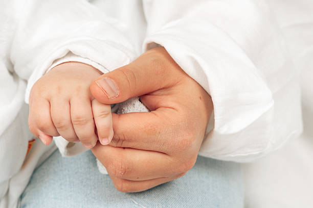 istock Parent and Baby Hand Holding Captured Close-Up 2210362255