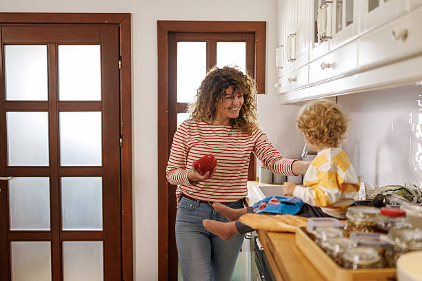 istock Helping mom with chores at home 2210362369