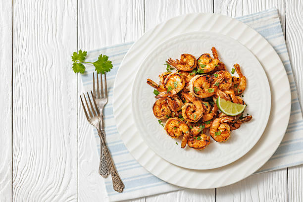 istock Grilled shrimp on a white plate with lime 2210362374