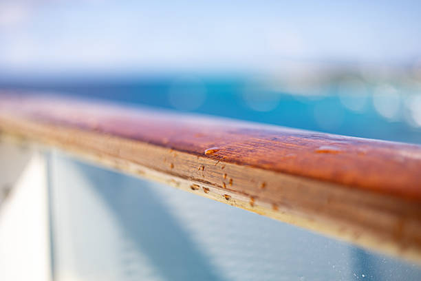 Close up of a wooden railing of a balcony on a cruise ship