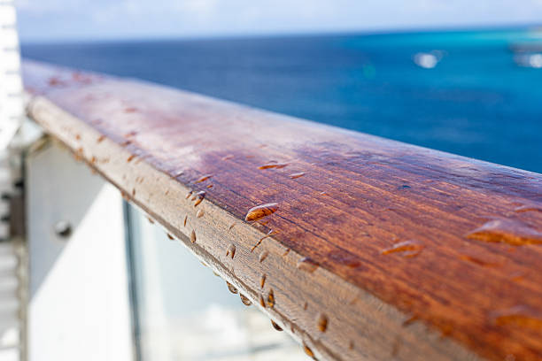 Blue sky, calm sea surface and wooden deck of ship with copy space