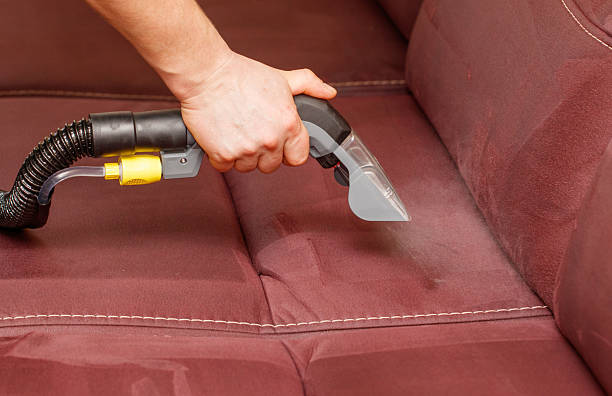 istock A person is cleaning a couch with a vacuum 2210363599